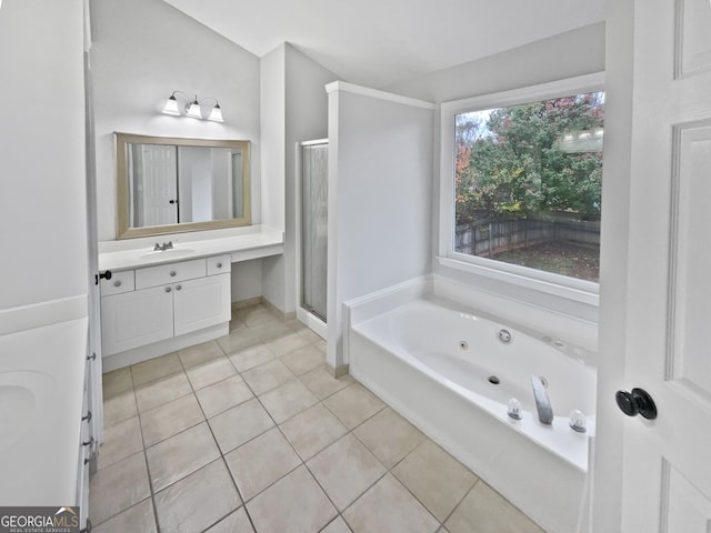 bathroom featuring tile patterned floors, vanity, and shower with separate bathtub