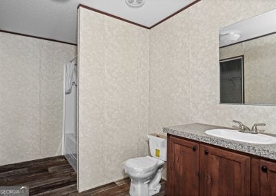 bathroom with vanity, toilet, wood-type flooring, and crown molding