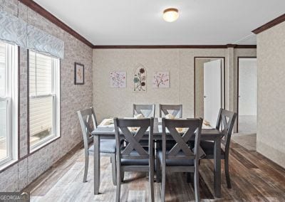 dining space with hardwood / wood-style flooring and ornamental molding