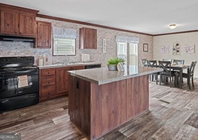 kitchen with crown molding, hardwood / wood-style floors, and black range