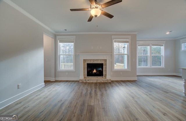 unfurnished living room with ceiling fan, light hardwood / wood-style floors, and ornamental molding