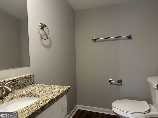 2190 Westover Dr, East Point, GA 30344 - half bathroom featuring wood finished floors, toilet, baseboards, and vanity