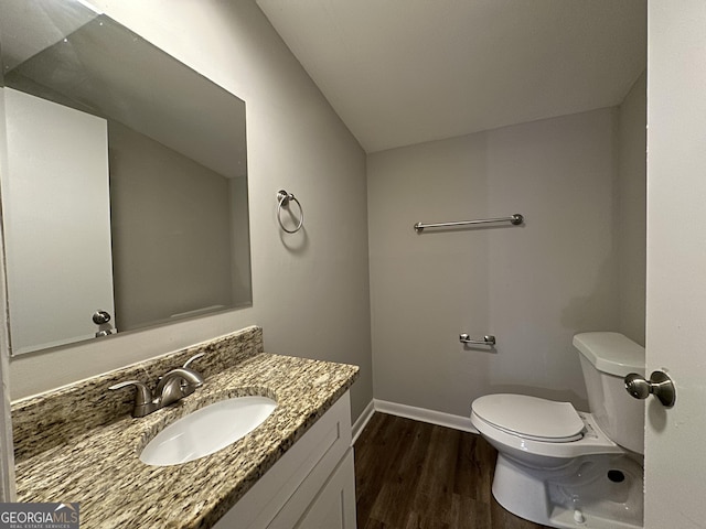 2190 Westover Dr, East Point, GA 30344 - bathroom with wood finished floors, toilet, baseboards, and vanity