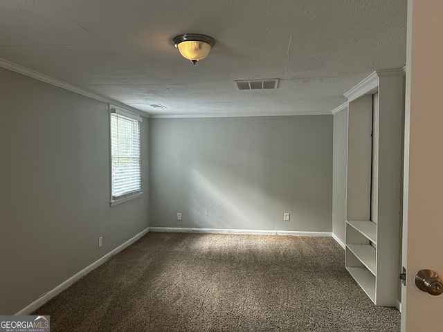 carpeted empty room featuring a textured ceiling and ornamental molding