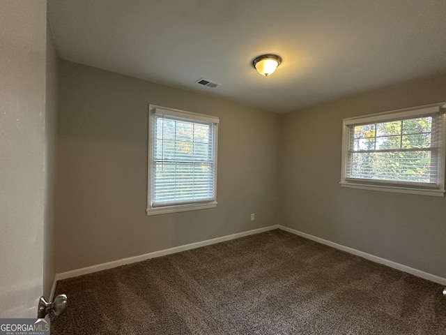 2190 Westover Dr, East Point, GA 30344 - spare room with plenty of natural light, dark colored carpet, and baseboards