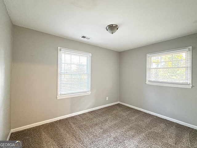 2190 Westover Dr, East Point, GA 30344 - empty room featuring healthy amount of natural light, dark colored carpet, and baseboards