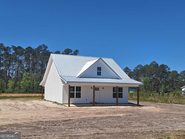view of front of property with a porch and metal roof