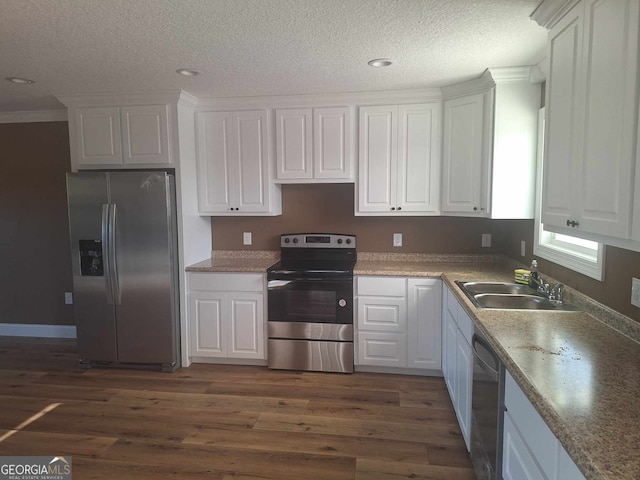 kitchen featuring white cabinets, appliances with stainless steel finishes, and a sink