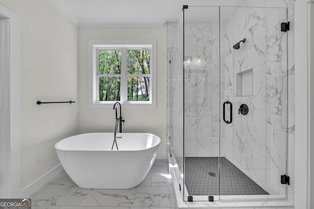 bathroom featuring marble finish floor, a marble finish shower, baseboards, and a freestanding bath