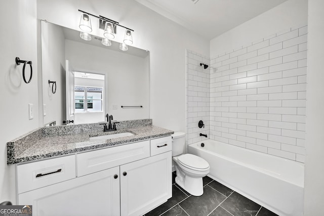 full bathroom with toilet, vanity, and tiled shower / bath