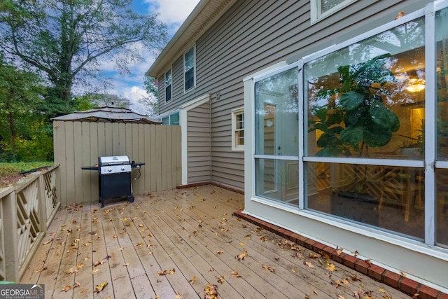 wooden terrace featuring grilling area