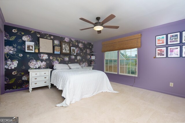 bedroom featuring light colored carpet, ceiling fan, and crown molding