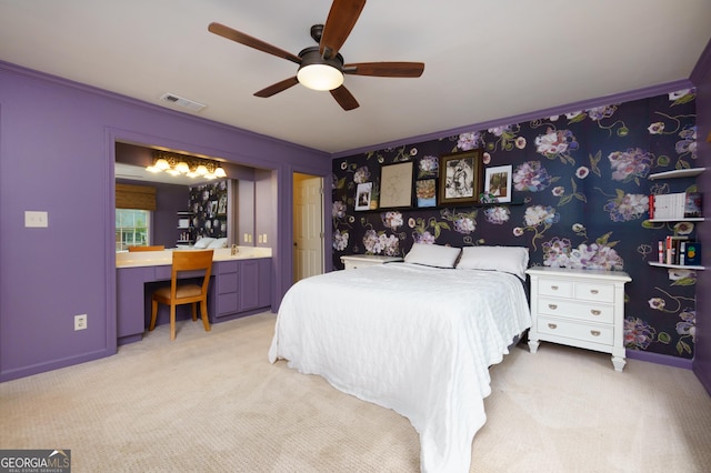 bedroom with ceiling fan, sink, crown molding, and light carpet