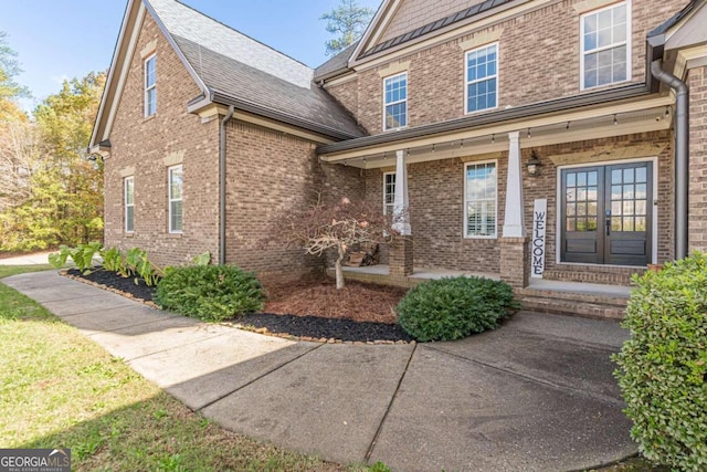 doorway to property featuring french doors and covered porch