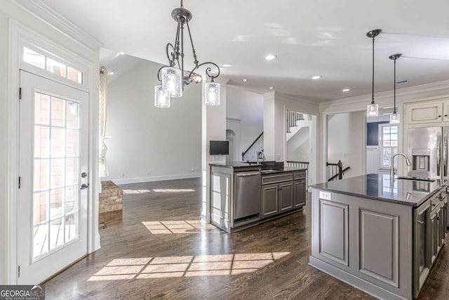 kitchen with crown molding, dishwasher, pendant lighting, and dark hardwood / wood-style floors