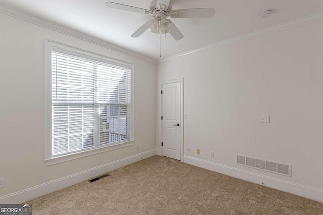 unfurnished room with light carpet, crown molding, and ceiling fan