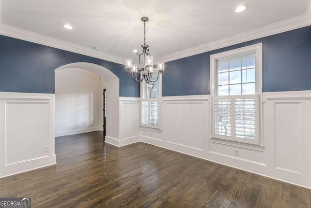 unfurnished dining area featuring a chandelier, dark hardwood / wood-style floors, and ornamental molding