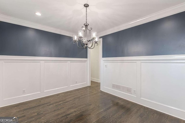 unfurnished dining area featuring a notable chandelier, dark hardwood / wood-style flooring, and ornamental molding