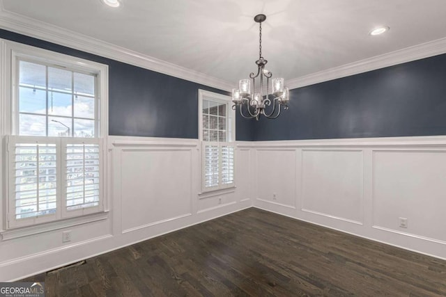 unfurnished dining area with a notable chandelier, dark hardwood / wood-style floors, and ornamental molding