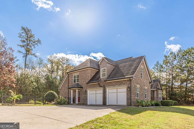 view of front of home with a garage and a front lawn