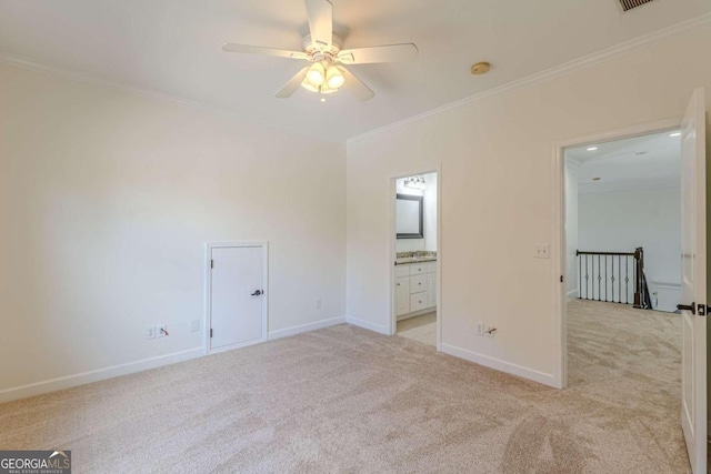 unfurnished bedroom with ceiling fan, light colored carpet, crown molding, and ensuite bath