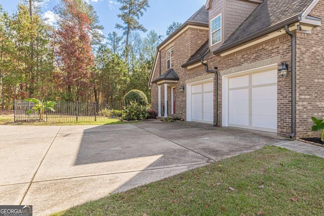 view of home's exterior featuring a garage and a lawn