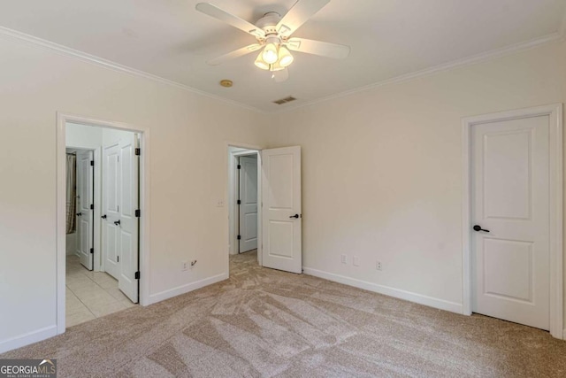 unfurnished bedroom with ceiling fan, ensuite bathroom, light colored carpet, and ornamental molding