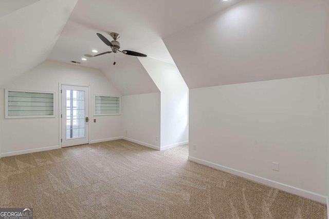 additional living space with ceiling fan, light carpet, and vaulted ceiling