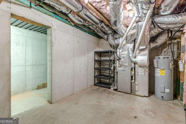 basement with electric water heater and heating unit