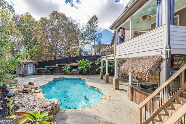 view of pool featuring a patio and a storage unit