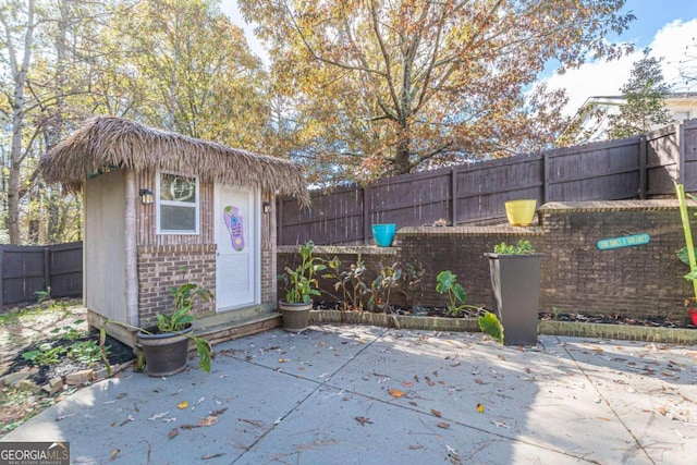 view of patio with a storage unit