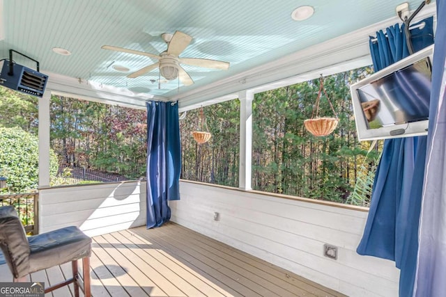 unfurnished sunroom with ceiling fan and a healthy amount of sunlight