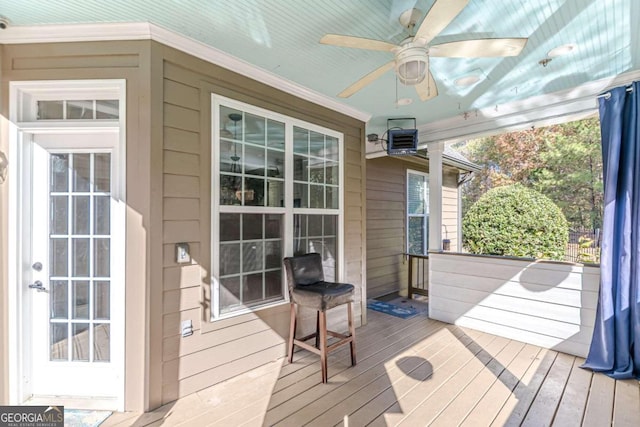 sunroom featuring ceiling fan