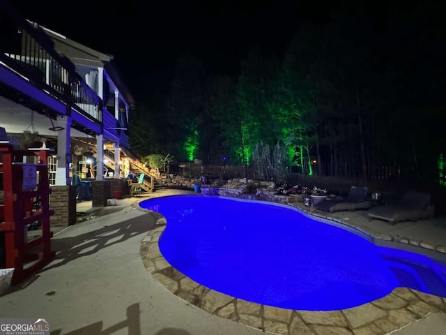 pool at night with a patio