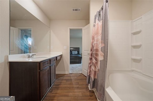 bathroom featuring vanity, wood-type flooring, and shower / bath combo with shower curtain