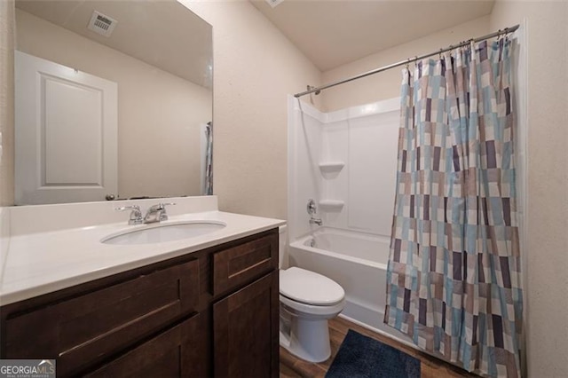 full bathroom with shower / tub combo with curtain, vanity, wood-type flooring, and toilet