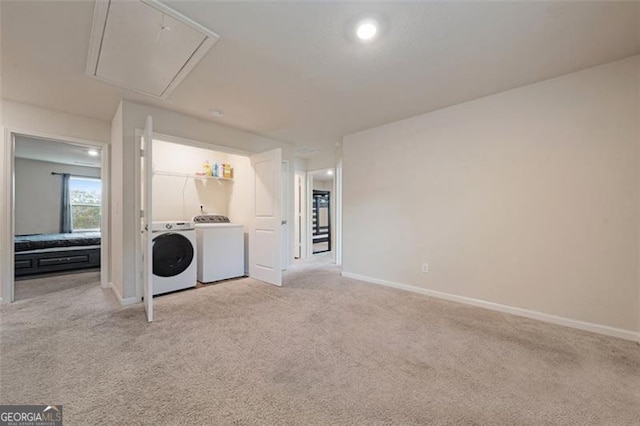 interior space featuring separate washer and dryer and light colored carpet