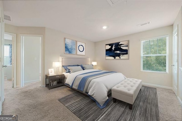 carpeted bedroom featuring multiple windows