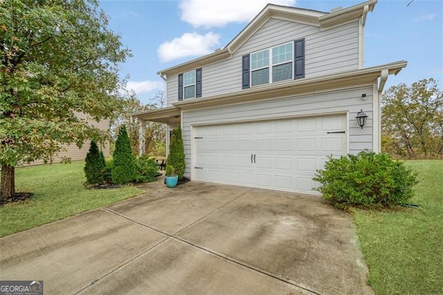 view of front of home with a front yard and a garage