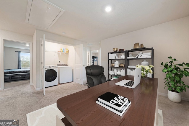 carpeted office featuring washer and dryer