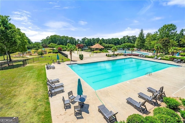 view of swimming pool with a lawn and a patio