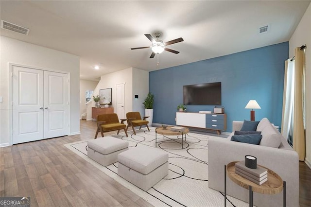 living room featuring hardwood / wood-style floors and ceiling fan