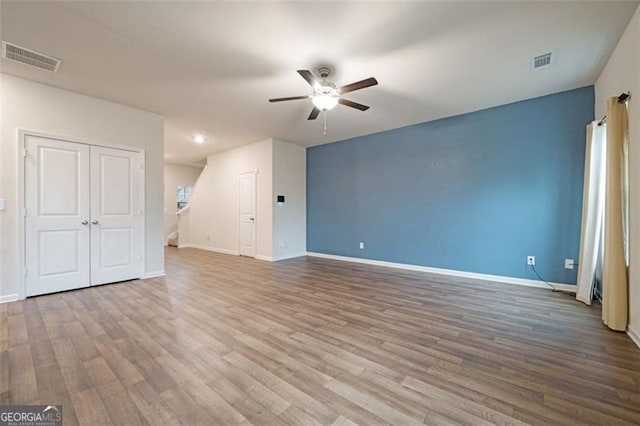 interior space with hardwood / wood-style floors and ceiling fan