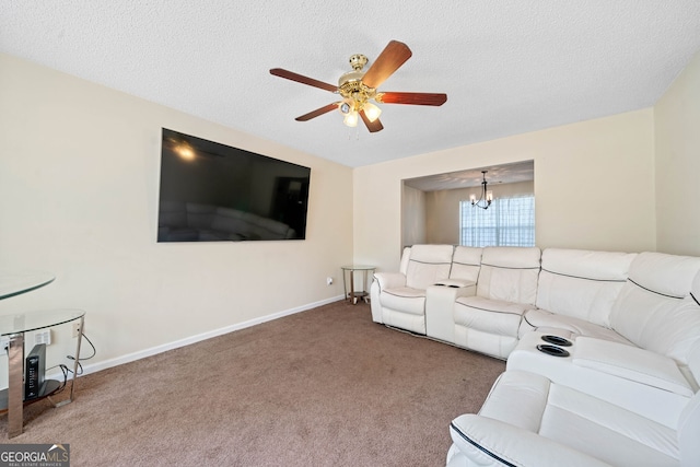 living room with ceiling fan with notable chandelier, carpet floors, and a textured ceiling