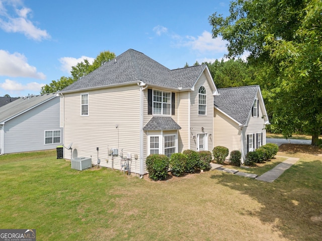 view of property exterior with a lawn and central AC unit