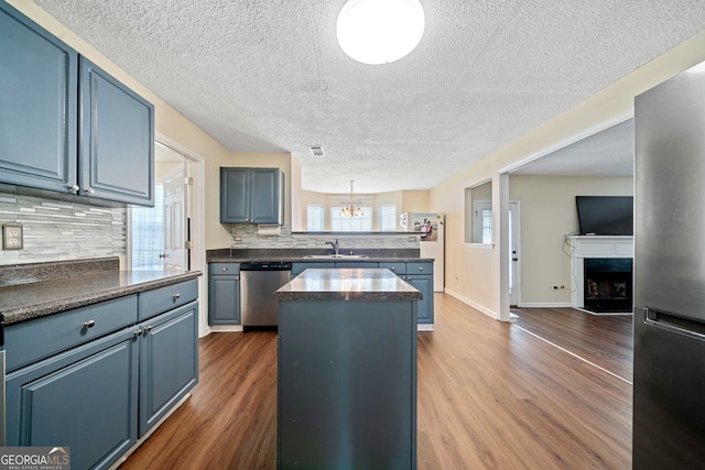 kitchen featuring a kitchen island, dark hardwood / wood-style flooring, stainless steel appliances, and tasteful backsplash