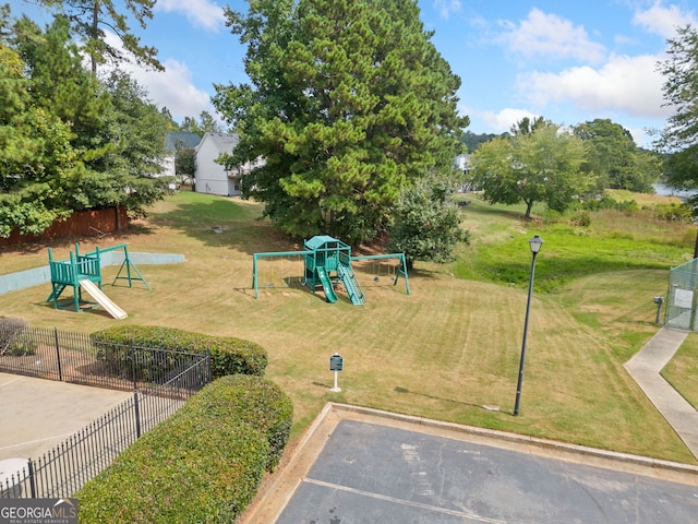 view of jungle gym featuring a lawn