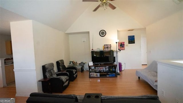 living room with high vaulted ceiling, light hardwood / wood-style flooring, and ceiling fan