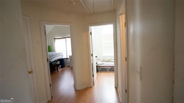 corridor with light wood-type flooring