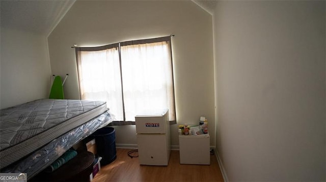 bedroom with hardwood / wood-style flooring